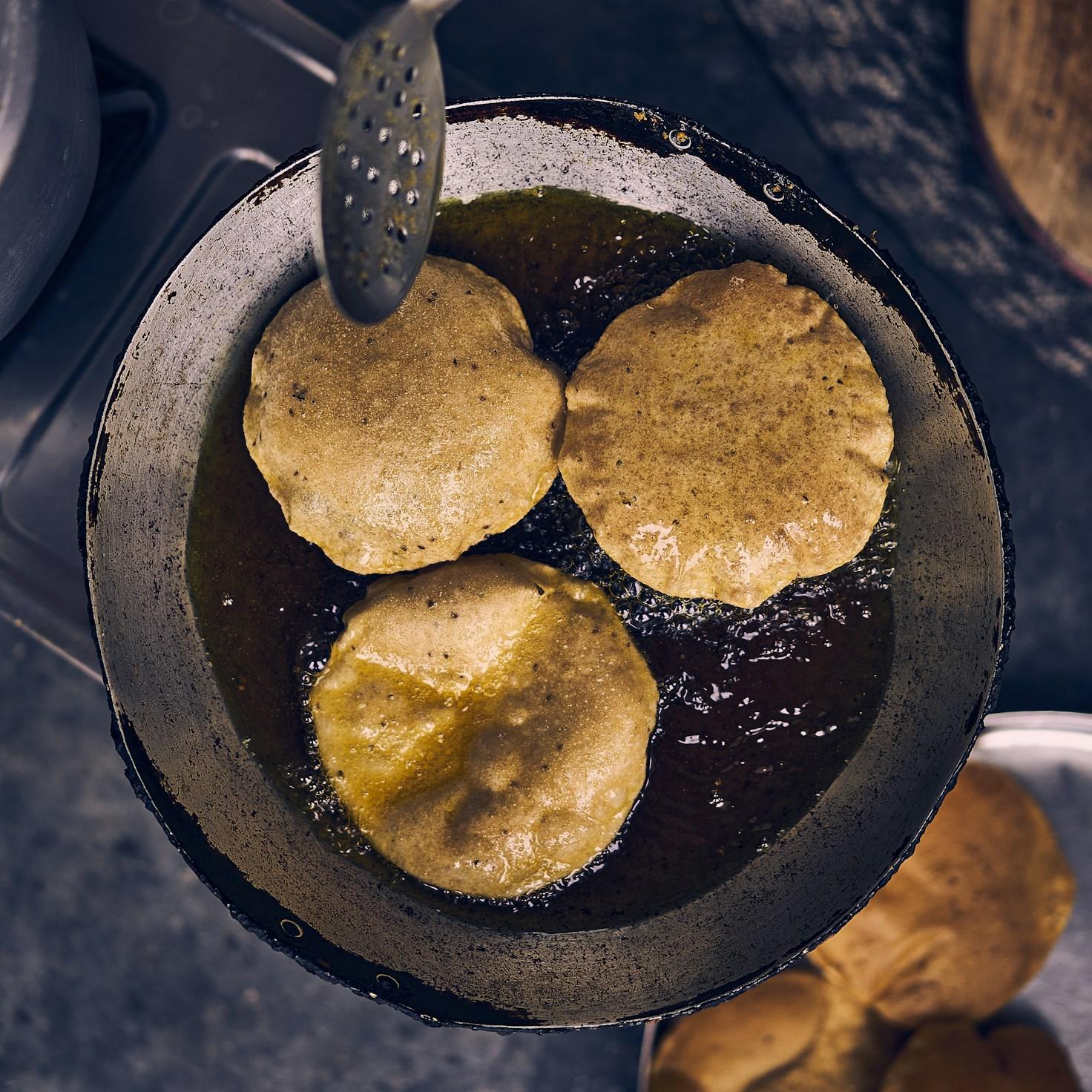 Community members collaborating in a modern kitchen space, exchanging recipes and techniques